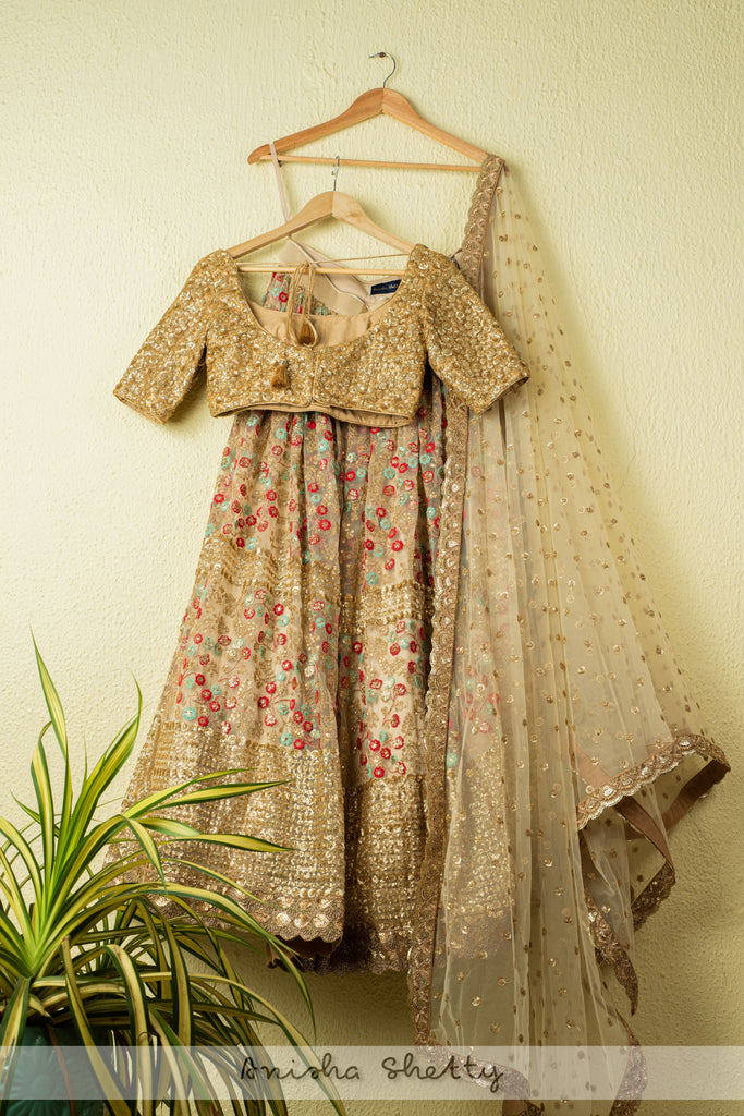 BEIGE LEHENGA WITH COLORFUL THREADWORK EMBROIDERY AND GOLD SEQUENCE BLOUSE